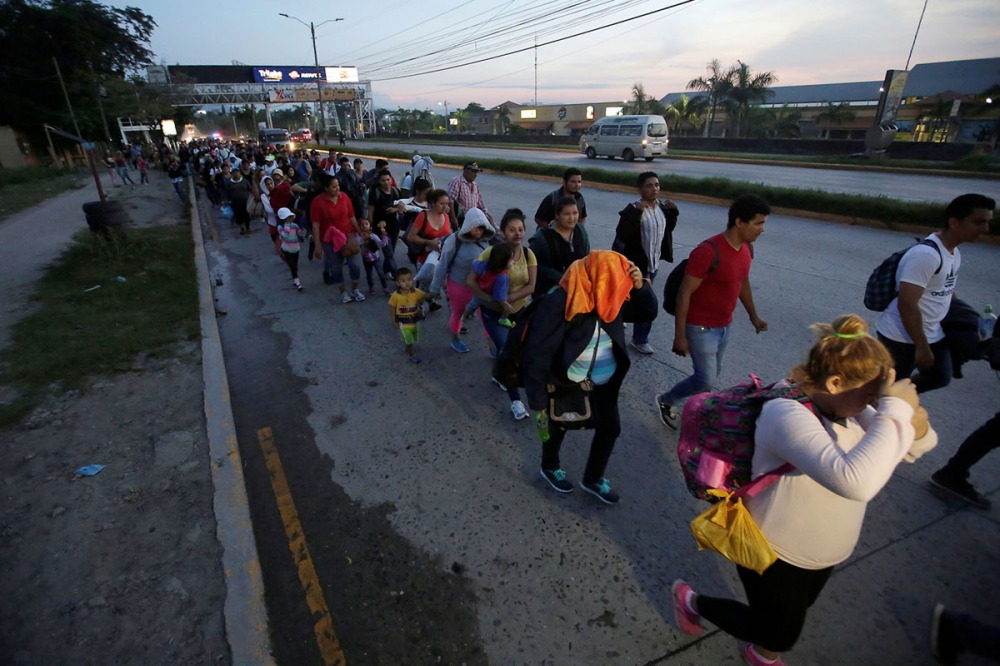 A large group of Hondurans fleeing poverty and violence, move in a caravan toward the United States, in San Pedro Sula