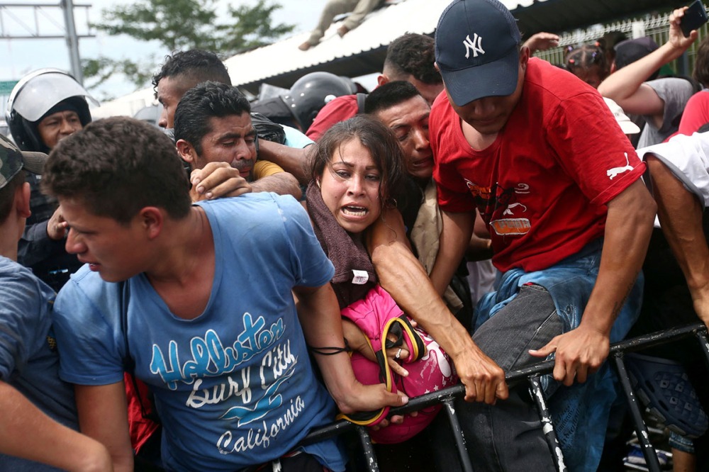 Honduran migrants, part of a caravan trying to reach the U.S., storm a border checkpoint in Guatemala, in Ciudad Hidalgo